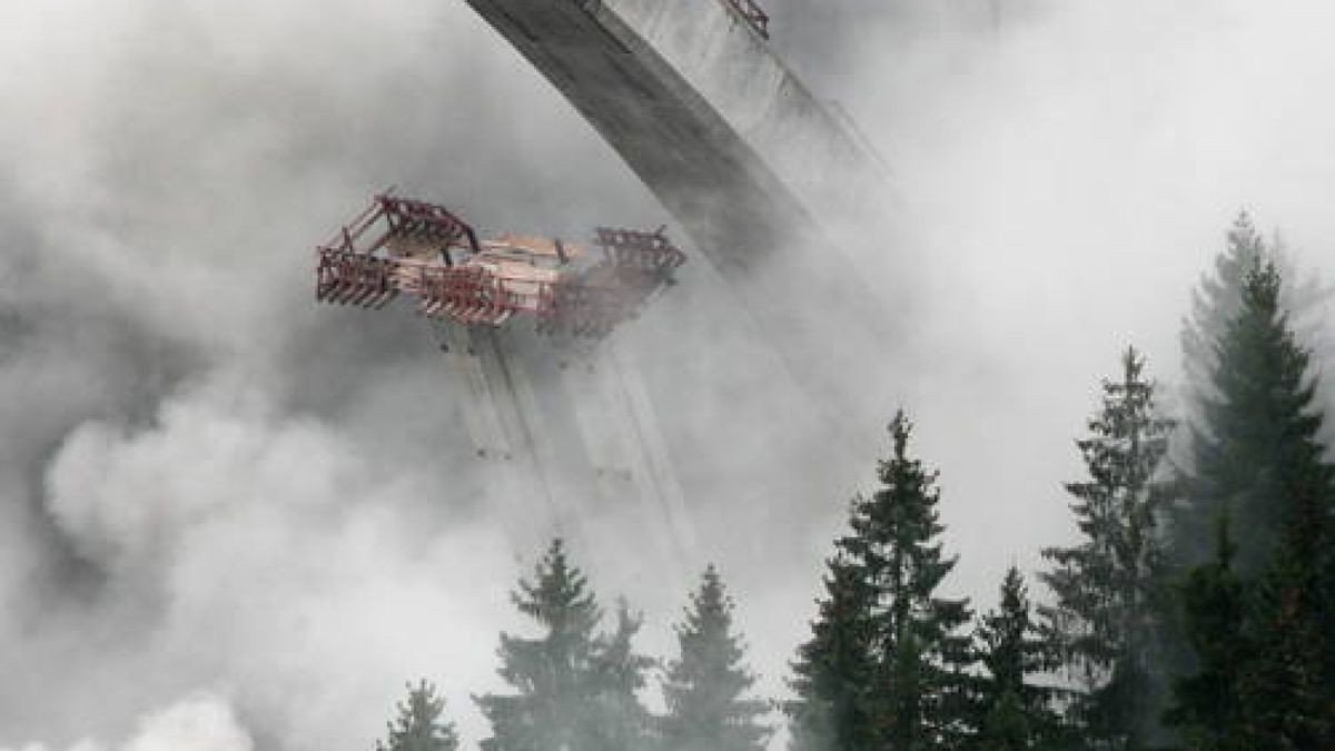 Sechs umkrachende Stützpfeiler wurden durch gezielte Explosionen unter der Brücke entfernt.