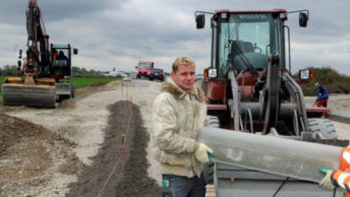 Der kleine Ort Dermsdorf bekommt gerade eine Ortsumgehung. Dafür sind 2,5 Kilometer Strecke und zwei Kreisverkehre gebaut worden, die vor der Fertigstellung sind. Jörg Römhild (links) und Mario Rolle setzen gestern Bordsteine am Kreisel in der Nähe der Streitseen. Foto: Ina Renke