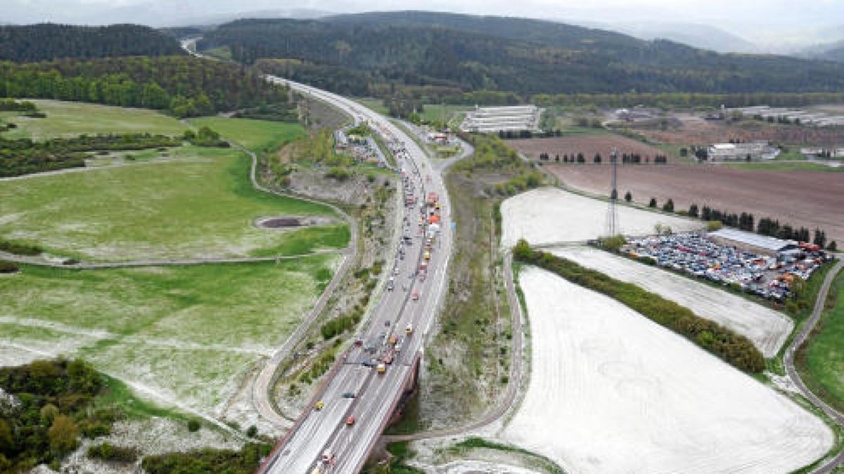 Das Foto des Polizeihubschraubers zeigt das Ausmaß der Unfälle mit Blick von Süden auf die Autobahn in Richtung Suhl. Auf der Fahrbahn und den Flächen ist noch nach mehr als einer Stunde die Auswirkungen des Hagels an den weißen Wiesen und Feldern zu sehen. Foto: Polizei    