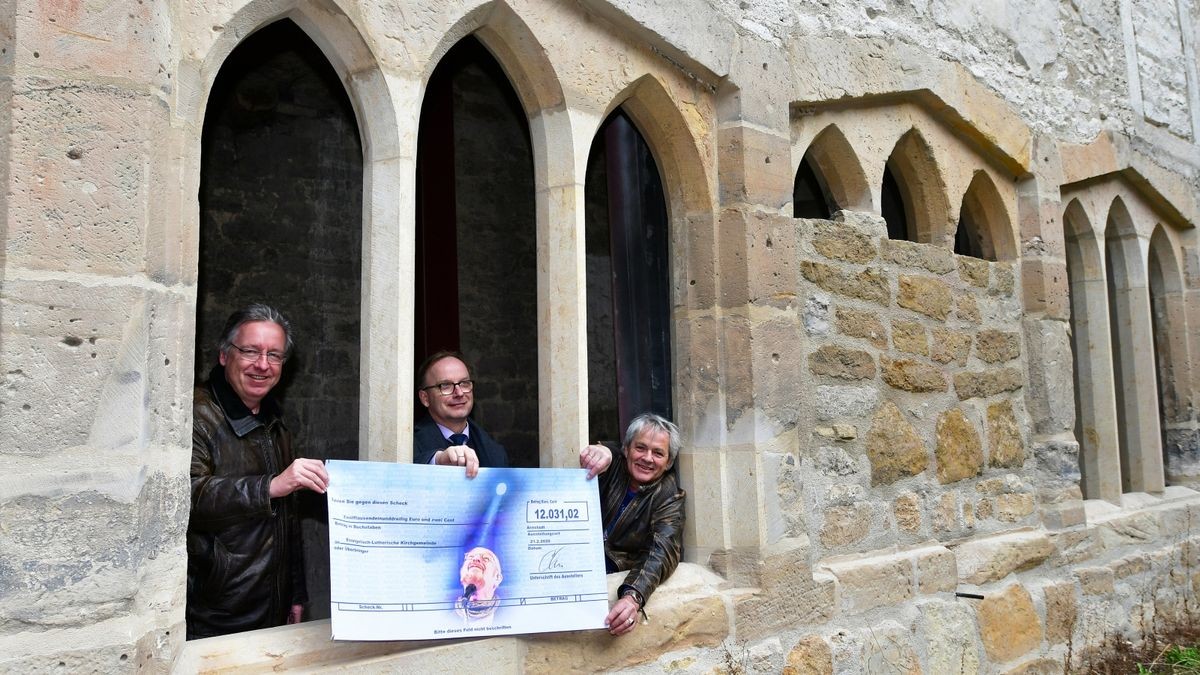 Rainer Pense (l.) und Christoph Hodgson (r.) vom Bach Advent in Arnstadt haben im März an Pfarrer Thomas Kratzer einen Scheck in Höhe von 12.031,02 Euro übergeben, gestiftet aus der Gage von Ian Anderson.