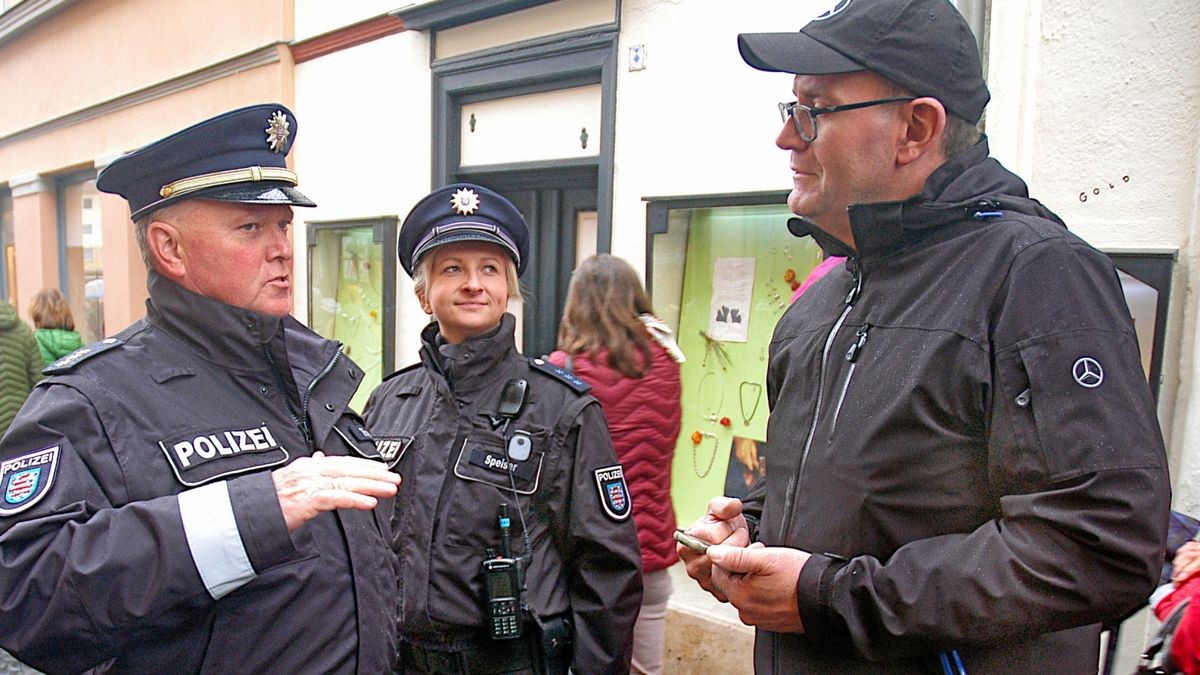 Der Weimarer Polizeichef René Treunert und die Polizeibeamtin Speiser im Gespräch mit einem Gast auf dem Zwiebelmarkt.