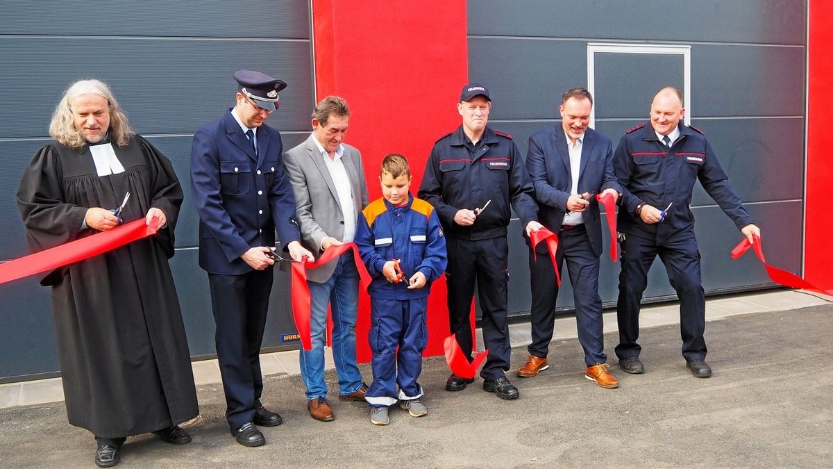 Pfarrer Jens Bechtloff, Vize-KBI Adrian Hesse, Landrat Harald Henning, Luca, Ortsbrandmeister Andreas Lauße, Bürgermeister Roman Zachar (AfLK), und Wehrführer Sandro Knauf schritten zur Tat.