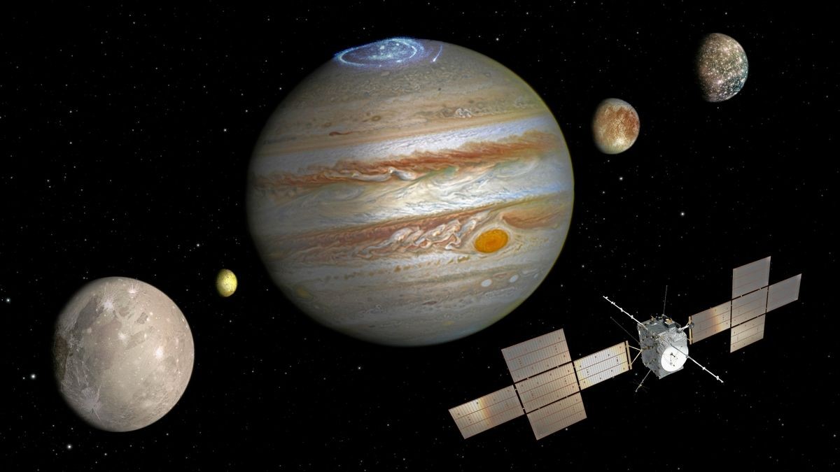 Die nicht maßstabsgetreue Abbildung zeigt die Sonde „Juice“, den Jupiter (Mitte) und die Monde (von links nach rechts) Ganymed, Io, Europa und Kallisto. An Bord der Sonde ist ein Teleskop aus Jena, das den Eismond Ganymed untersuchen soll. 