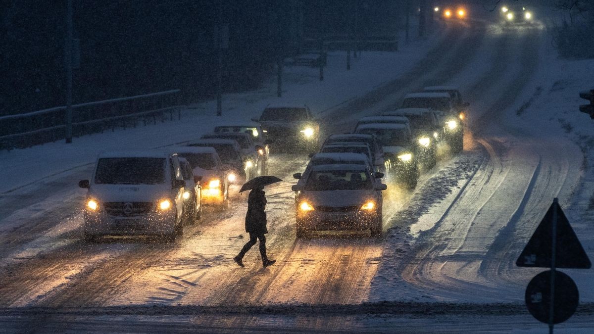 Ein Fußgänger geht am späten Nachmittag über die verschneite Erfurter Staufenbergallee.