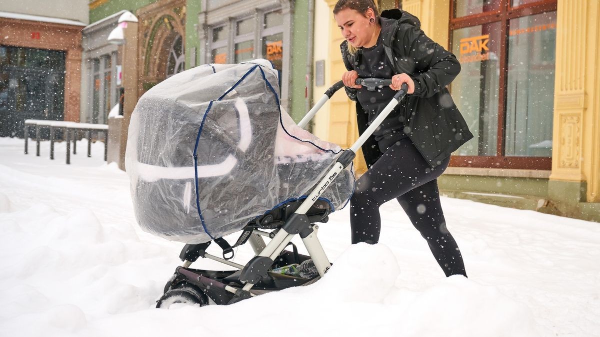 Sophie Hopf hat es mit ihrem Kinderwagen im hohen Schnee auf dem Gothaer Hauptmarkt schwer.