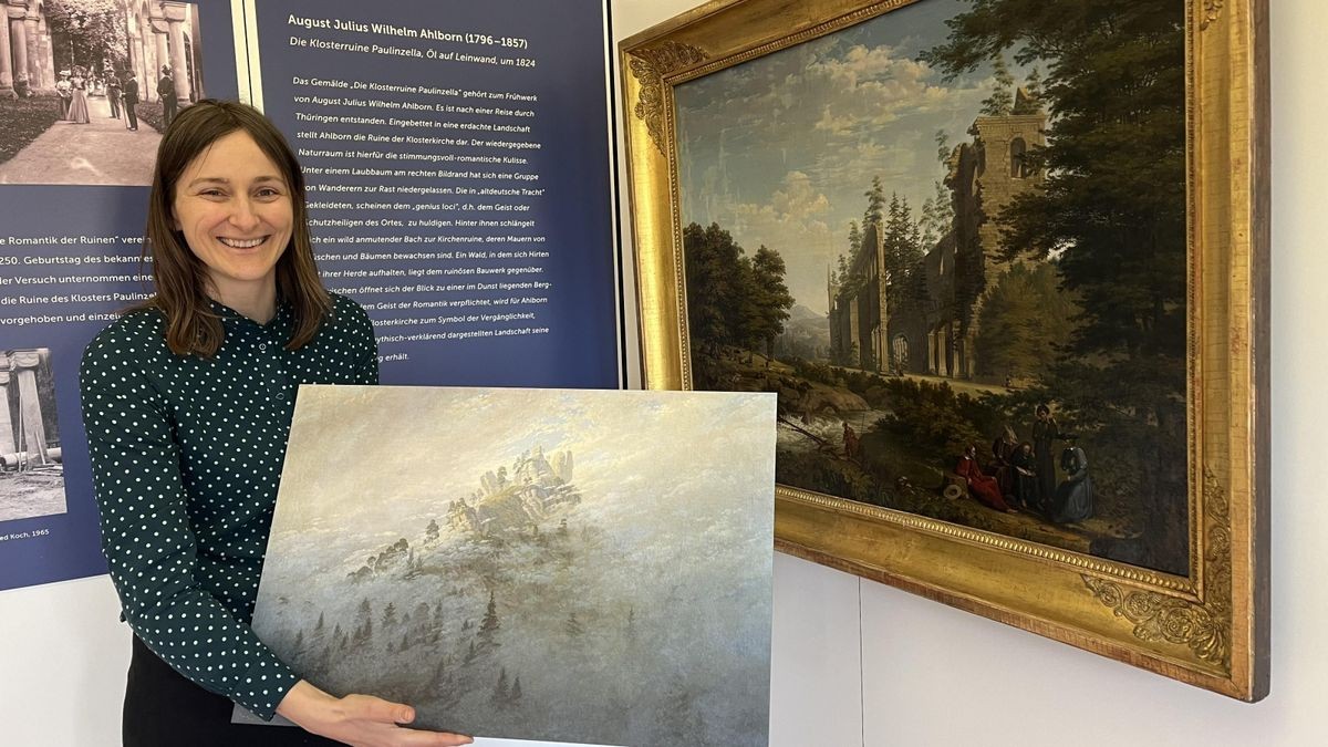 Sabrina Lüderitz, Direktorin im Thüringer Landesmuseum Heidecksburg, mit der Reproduktion von Caspar David Friedrichs „Morgennebel im Gebirge“ (Original von 1808) und vor dem Ölgemälde „Die Klosterruine Paulinzella“ von August Julius Wilhelm Ahlborn (1824). Sie sind Teil der neuen Ausstellung „Verfall & Sehnsucht. Die Romantik der Ruinen“  im Amtshaus des Thüringen Forst im Kloster Paulinzella. 