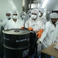 (FILES) Iranian technicians remove a container of radioactive uranium, 'yellow cake', sealed by the International Atomic Energy Agency, to be used at the Isfahan Uranium Conversion Facilities (UCF), 420 kms south of Tehran, on August 8, 2005. Israel unleashed a wave of strikes on Iran on June 13, hitting about 100 targets including nuclear facilities and military command centres, and killing senior figures, among them the armed forces chief and top nuclear scientists. (Photo by Behrouz MEHRI / AFP)