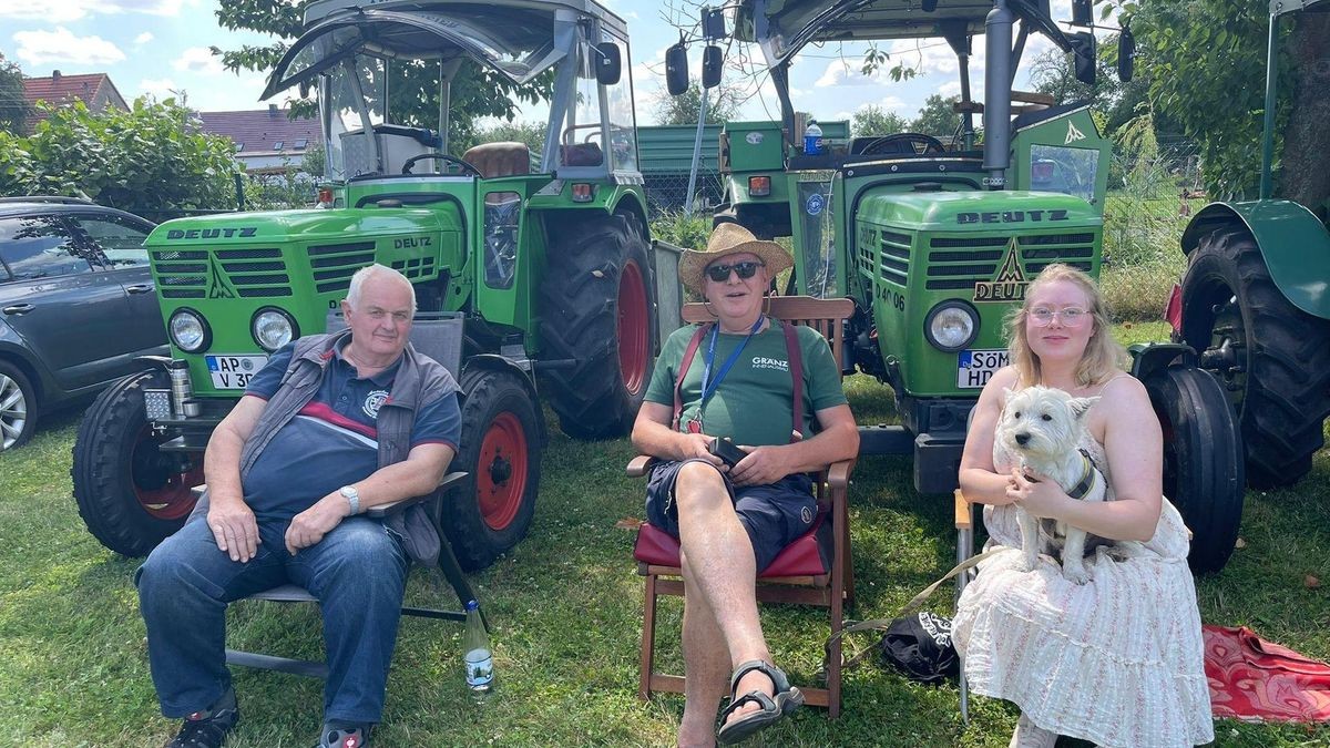 Helmut Hage (von links), Matthias Horn und Anasthasia Horn präsentieren historische landwirtschaftliche Fahrzeuge – darunter ein Deutz 4006 Traktor aus dem Jahr 1975.