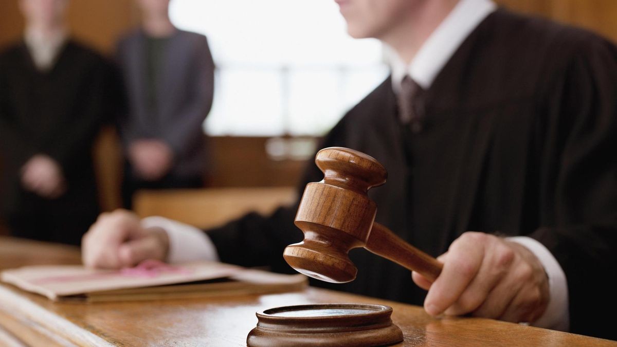 Judge holding gavel in courtroom