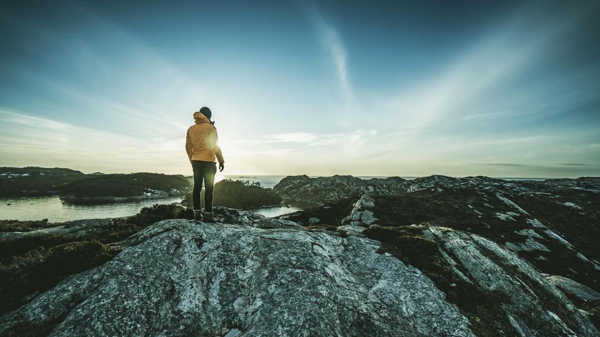 Man mountain hiking by a fjord in Norway