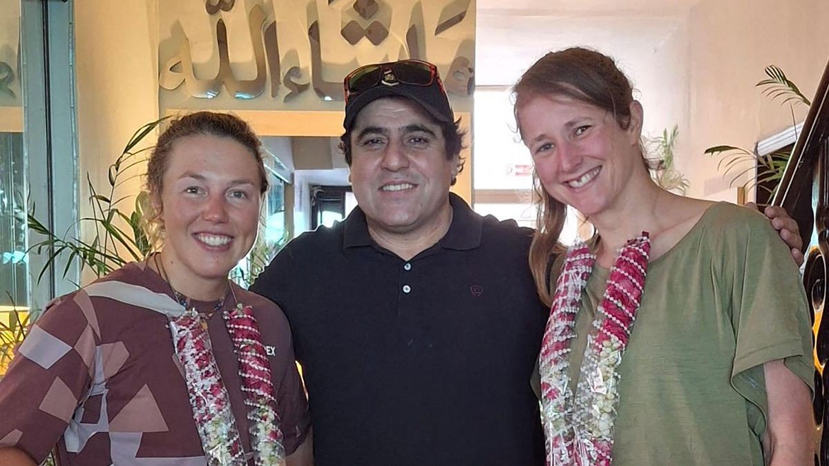 This handout photograph taken on June 29, 2025 and released by Shipton Trek and Tours Pakistan shows German double biathlon champion Laura Dahlmeier (L) posing for photographs with her mountaineering partner Marina Eva (R) alongside tour operator Muhammad Iqbal Shigri, upon their arrival in Islamabad. A team of foreign climbers were on July 30, due to launch a rescue mission for Dahlmeier, days after she was seriously injured by a rockfall on a Pakistani mountain. (Photo by Shipton Trek and Tours Pakistan / AFP) / RESTRICTED TO EDITORIAL USE - MANDATORY CREDIT 